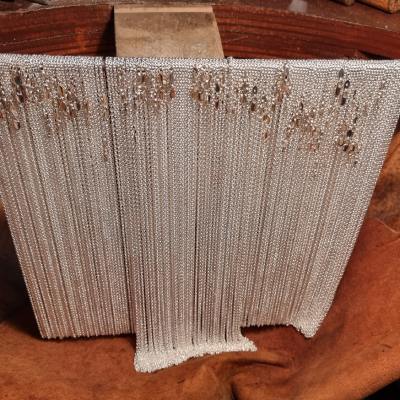 Sterling Silver Chains - all put together by hand - hanging over the silversmith skin below the silversmith bench