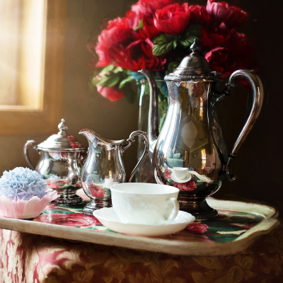 SIlverware Tea Service may need some repairs, sitting on a tray with sunlight rays
